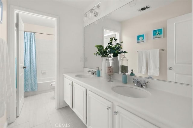 full bathroom with toilet, vanity, tile patterned flooring, and shower / bath combo with shower curtain