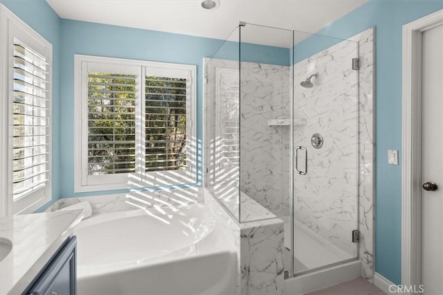 bathroom featuring separate shower and tub and vanity