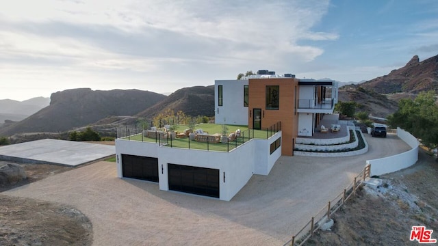 exterior space with a mountain view and a balcony