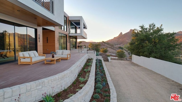 yard at dusk with a mountain view and outdoor lounge area