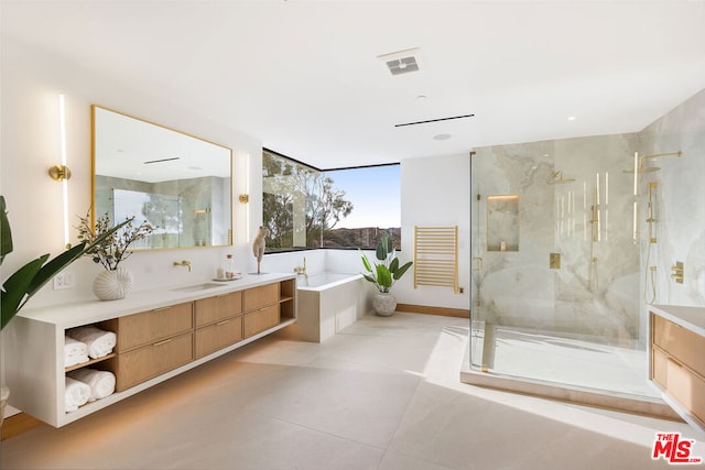 bathroom with tile patterned floors, vanity, and plus walk in shower