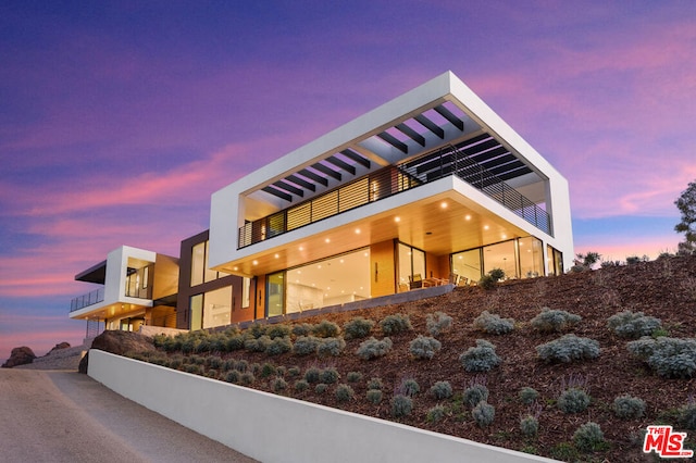 view of outdoor building at dusk