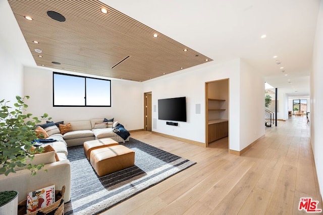 living room featuring wooden ceiling, built in features, and light hardwood / wood-style floors