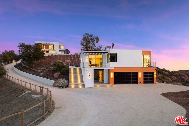 view of front of property with a balcony and a garage