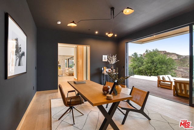 dining area featuring light hardwood / wood-style floors and a mountain view