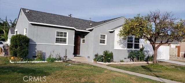 view of front facade with a front lawn and a garage