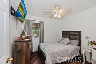 bedroom featuring ceiling fan and dark hardwood / wood-style floors