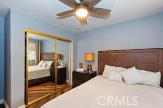 bedroom with ceiling fan and a closet