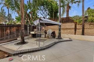 view of patio with a gazebo and a playground