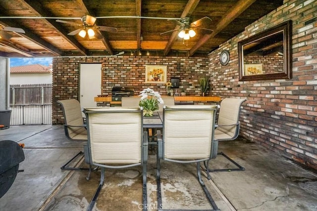 bar with concrete floors, beamed ceiling, and brick wall