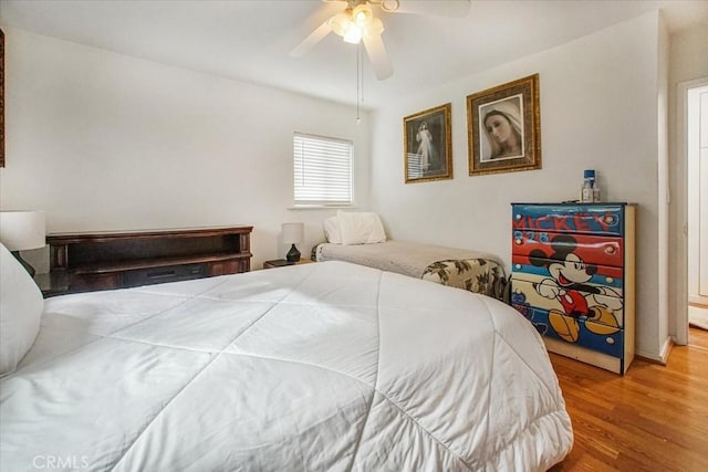 bedroom with ceiling fan and wood finished floors