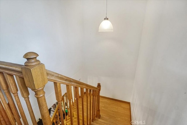 stairs with baseboards and wood finished floors