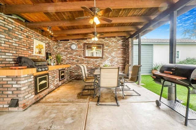 view of patio with outdoor dining space, ceiling fan, grilling area, and area for grilling