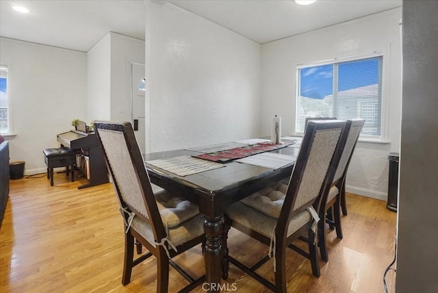 dining room featuring light wood-style floors and baseboards