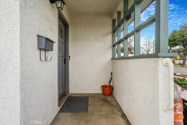 property entrance with stucco siding