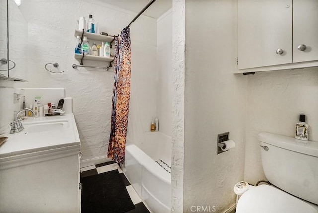 full bath with a textured wall, toilet, shower / tub combo, vanity, and tile patterned floors