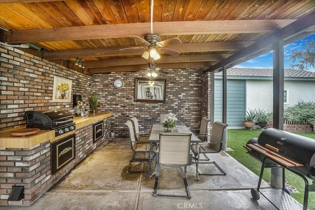 interior space featuring ceiling fan, grilling area, exterior kitchen, and outdoor dining space