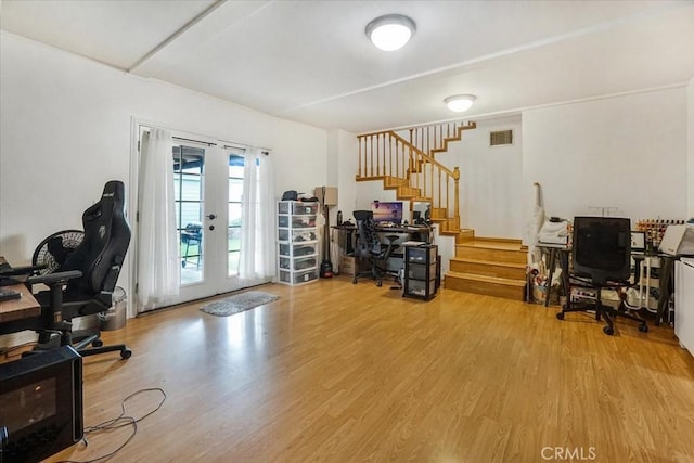 home office featuring visible vents, wood finished floors, and french doors