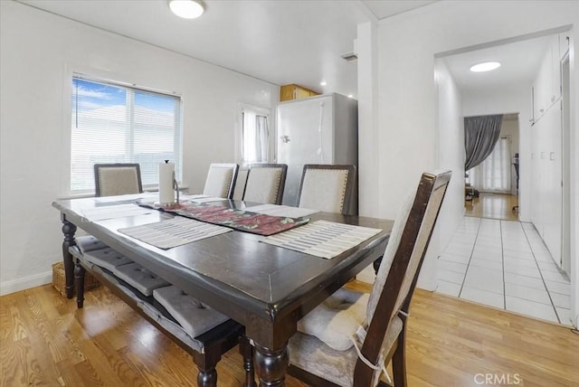 dining space with light wood-style floors