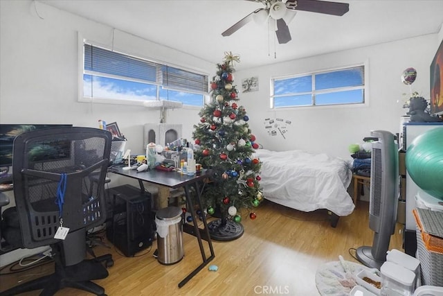 bedroom with ceiling fan and wood finished floors