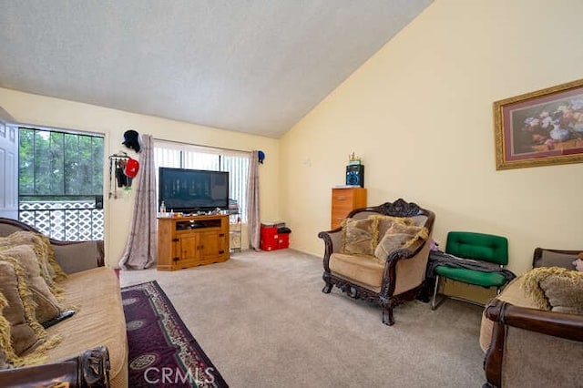 living room featuring light colored carpet, vaulted ceiling, and a textured ceiling