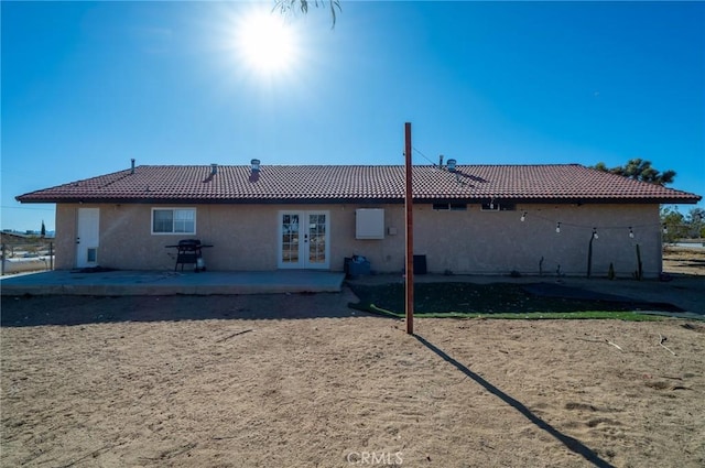 rear view of property with french doors and a patio area