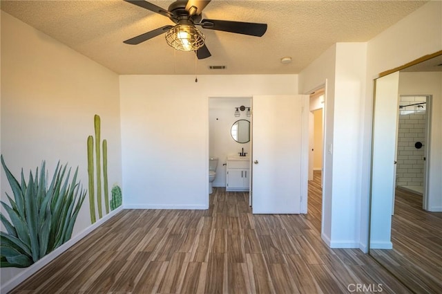 58168 Canterbury St, Yucca Valley, CA 92284 - unfurnished bedroom with wood finished floors, a textured ceiling, ensuite bath, and ceiling fan
