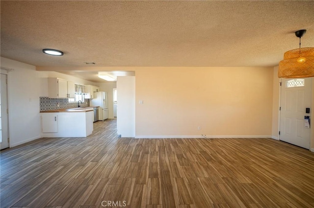 58168 Canterbury St, Yucca Valley, CA 92284 - unfurnished living room featuring wood finished floors and a textured ceiling