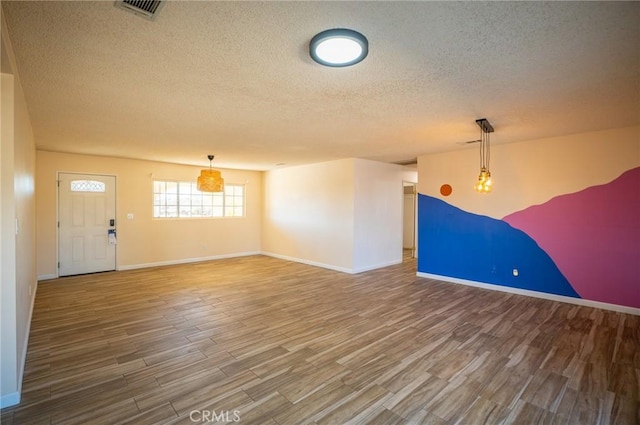 58168 Canterbury St, Yucca Valley, CA 92284 - unfurnished living room featuring wood finished floors and a textured ceiling