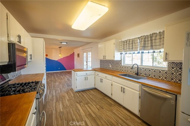 58168 Canterbury St, Yucca Valley, CA 92284 - kitchen featuring appliances with stainless steel finishes, butcher block counters, and decorative backsplash