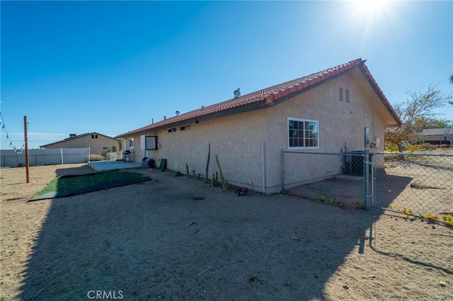 58168 Canterbury St, Yucca Valley, CA 92284 - back of property with stucco siding and a tile roof