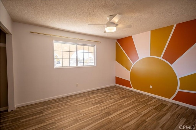 58168 Canterbury St, Yucca Valley, CA 92284 - unfurnished room featuring wood finished floors, a textured ceiling, and ceiling fan
