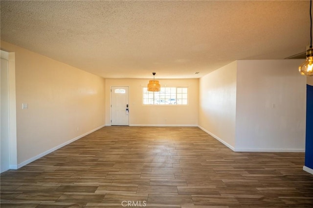 interior space featuring a textured ceiling and dark hardwood / wood-style floors