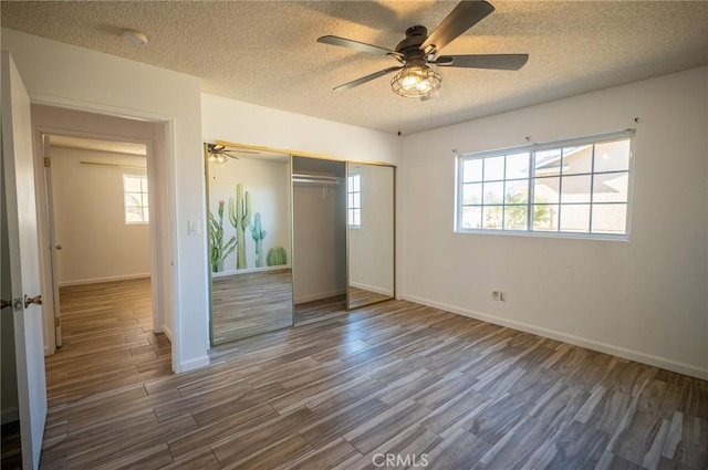 58168 Canterbury St, Yucca Valley, CA 92284 - unfurnished bedroom featuring a closet, a textured ceiling, wood finished floors, and a ceiling fan
