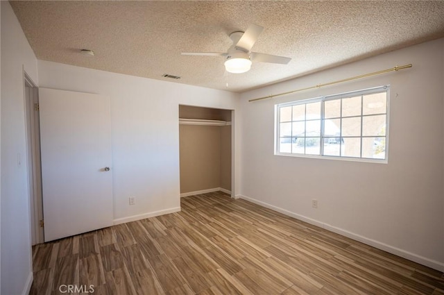 58168 Canterbury St, Yucca Valley, CA 92284 - unfurnished bedroom featuring a textured ceiling, wood finished floors, a closet, and ceiling fan