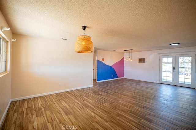 58168 Canterbury St, Yucca Valley, CA 92284 - empty room featuring a textured ceiling, wood finished floors, and french doors