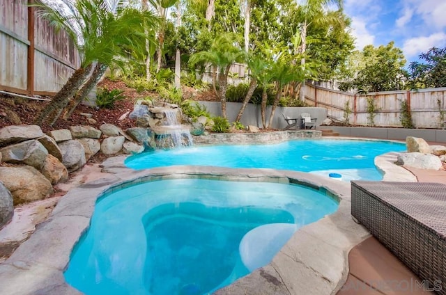 view of swimming pool featuring an in ground hot tub