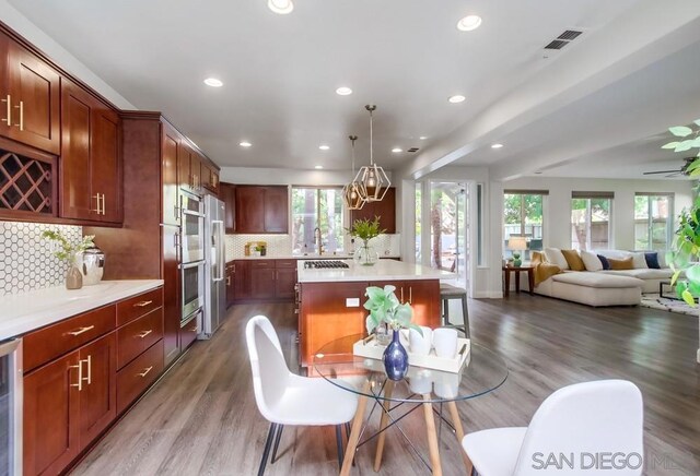 dining room with hardwood / wood-style flooring, sink, and a chandelier