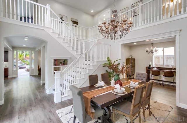 dining room featuring a chandelier, a high ceiling, and hardwood / wood-style floors