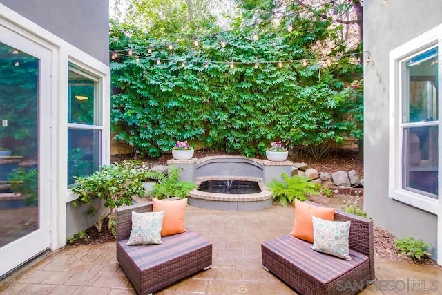 view of patio with a fire pit