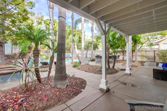 view of patio with a fenced in pool