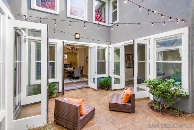 sunroom / solarium with a notable chandelier