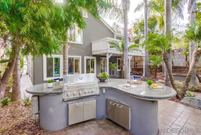 view of patio / terrace featuring a balcony, grilling area, and sink