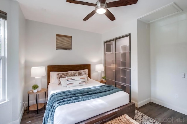 bedroom with ceiling fan and dark hardwood / wood-style floors