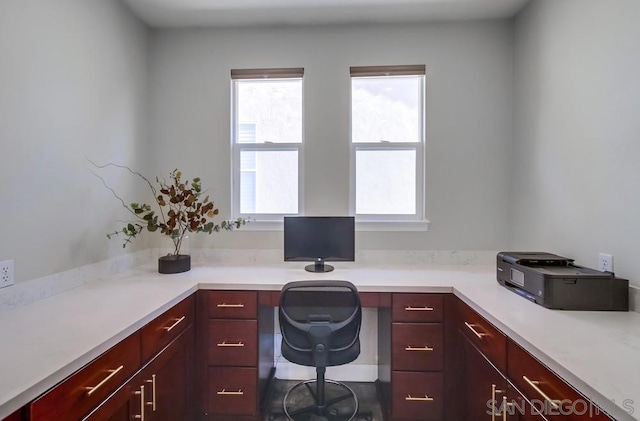 unfurnished office featuring built in desk