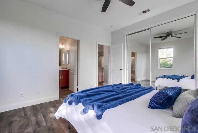 bedroom featuring a closet, dark hardwood / wood-style floors, ceiling fan, and ensuite bathroom