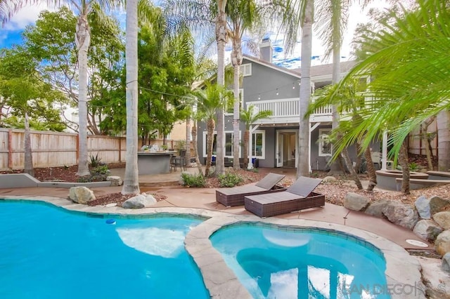 view of swimming pool with a jacuzzi