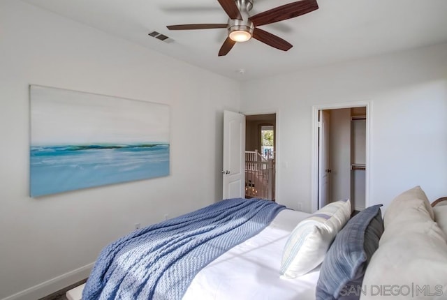 bedroom featuring a walk in closet, ceiling fan, and a closet