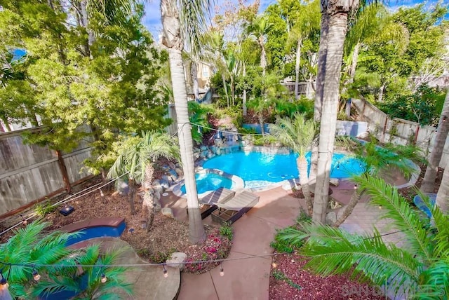 view of swimming pool with an in ground hot tub and a patio