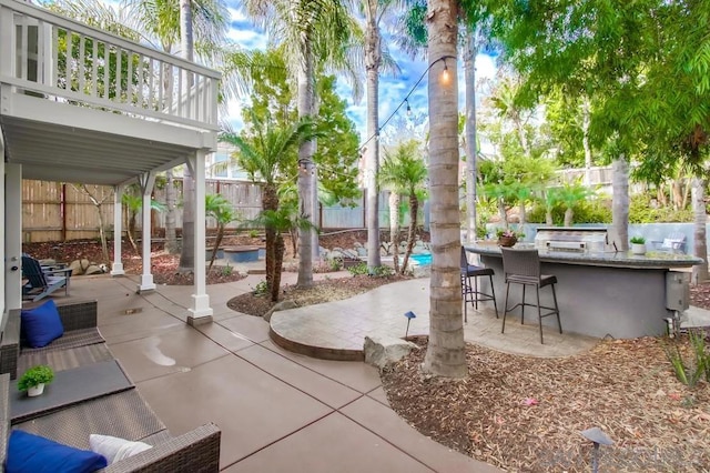 view of patio with an outdoor bar